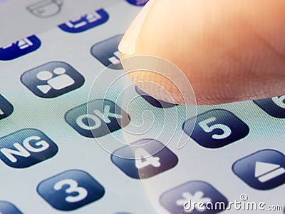 Closeup finger taping icon on screen keyboard Stock Photo