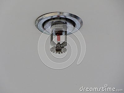 Closeup of Fire sprinkler install on white high ceiling Stock Photo