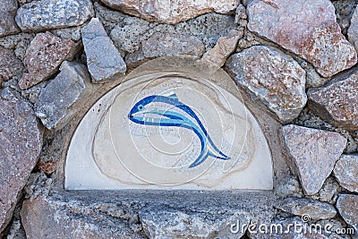 Closeup fish mosaic tiles on an old wall Stock Photo