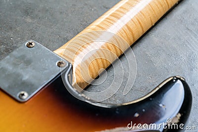 Closeup of flame maple neck on sunburst guitar Stock Photo