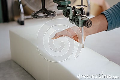 Closeup of a foam cutter machine, cutting through an upholstery foam Stock Photo