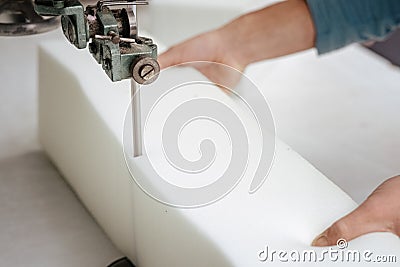 Closeup of a foam cutter machine, cutting through an upholstery foam Stock Photo