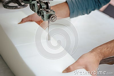 Closeup of a foam cutter machine, cutting through an upholstery foam Stock Photo