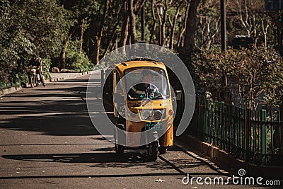 Closeup focus shot of a man driving an auto rickshaw Editorial Stock Photo