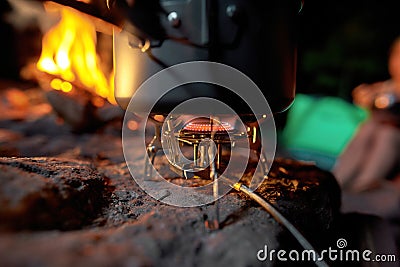 Closeup of foldable camping gas fire system with gas and a pot for fast heating Stock Photo