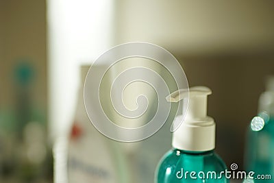 Closeup fragment of an aquamarine gel bottle with white dispenser Stock Photo