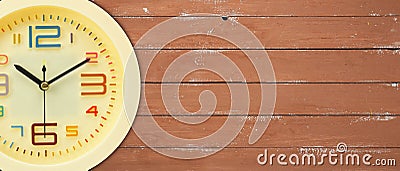 Fragment yellow alarm clock wooden background Stock Photo