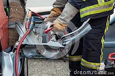 french rescue man with pneumatic machine on crashed c Stock Photo