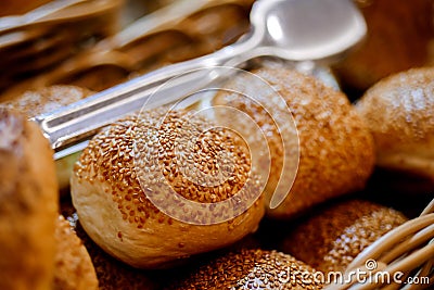 Closeup of fresh baked buns on tray. Buns with sesame seeds served for breakfast on buffet line Stock Photo