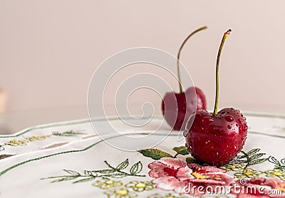 Closeup of fresh cherries with waterdrops on a plate Stock Photo