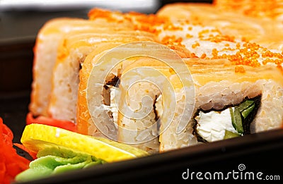 Closeup fresh maki sushi on black plate Stock Photo