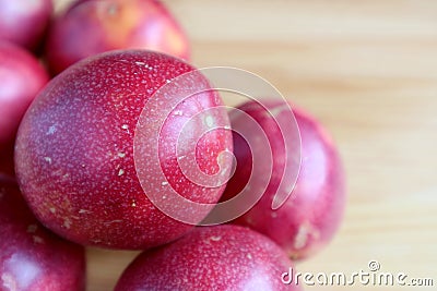 Closeup a Fresh Ripe Passion Fruit on the Pile on Wooden Table Stock Photo