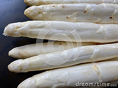 Closeup of fresh unpeeled white asparagus Stock Photo