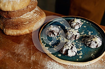 Closeup freshly made cookies on plate and bread on wooden table Stock Photo