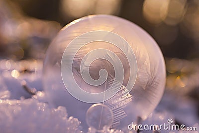 Closeup of a frozen crystal ball in an icy environment Stock Photo