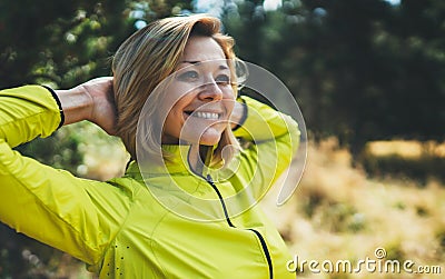 Closeup fun girl exercising outdoors in sun summer day, smile fitness woman stretching exercises training outside in park Stock Photo