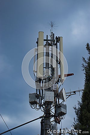 Closeup of a 4g 5g communications mobile tower on top of a hill, antennas for broadcasting signals Stock Photo