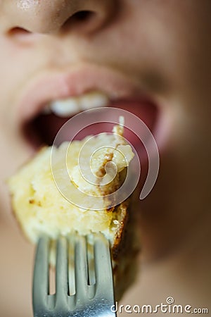 Closeup of girl about to eat delicious potato omelette from fork Stock Photo
