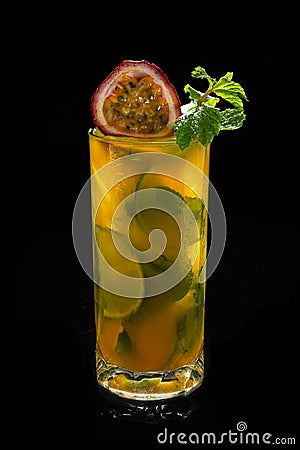 Closeup glass of Mojito with passion fruit maracuya lime and green leaf mint isolated Stock Photo