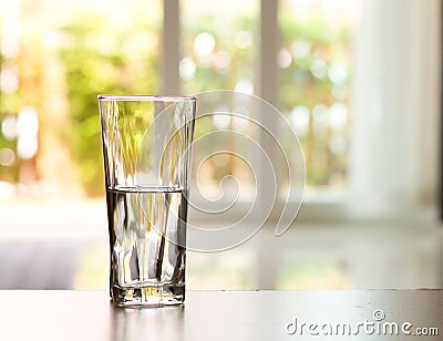 Closeup Glass of water on table in the living room , vintage and retro style Stock Photo