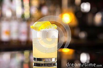 Closeup glass of whiskey sour cocktail decorated with lemon at b Stock Photo