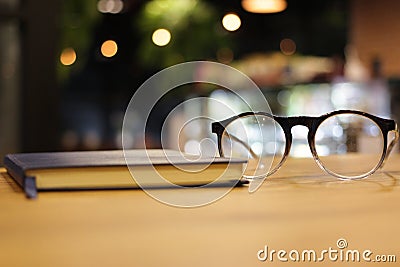 Closeup glasses and notebook at coffee cafe. reading and working Stock Photo