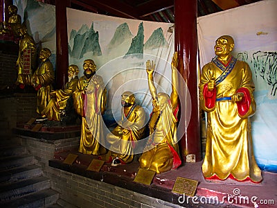 Closeup of a golden Shaolin monk`s Statues in Shaolin Temple. The Shaolin Monastery is also known as the Shaolin Temple. Dengfeng Editorial Stock Photo