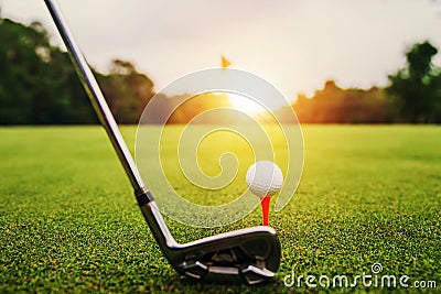 closeup golf club and golf ball on green grass wiht sunset Stock Photo