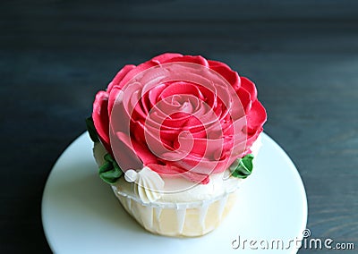 Closeup gorgeous cupcake decorated with red rose shaped whipped cream with copy space Stock Photo