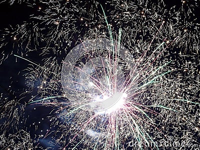 Closeup of green, red and yellow fireworks against a night sky, new year, party Stock Photo