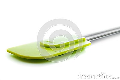 Closeup of green silicone kitchen accessory, spatula, lying on w Stock Photo