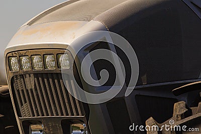closeup grey metal bonnet of tractor and large wheel Stock Photo