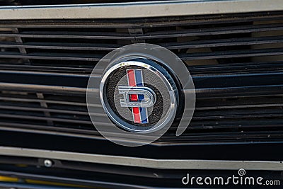 Closeup of grill emblem of a beautiful shiny Nissan Datsun 1200 car Editorial Stock Photo