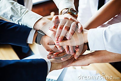 Closeup of a group of businesspeople joining their hands together. Stock Photo