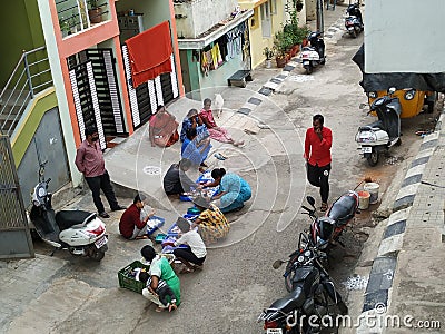 Closeup of Group of Indian Ladies purchasing hair pin, nail polish, and other ladies beauty accessories in roadside residential Editorial Stock Photo