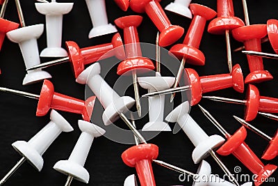 Closeup of group of pushpin thumbtack on black background Stock Photo