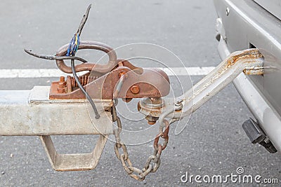 Closeup grungy tow car with connected hook and chain. Stock Photo