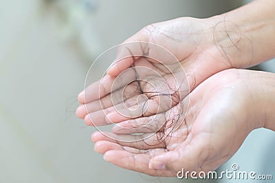 Closeup Hair loss on woman hand in the bathroom Stock Photo