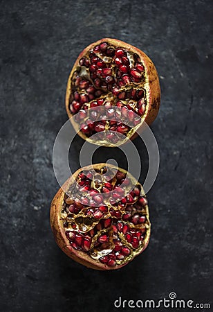 Closeup of half fresh pomegranate on black background Stock Photo