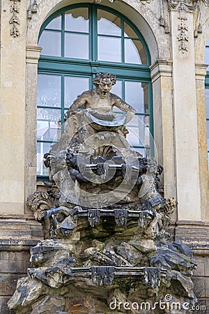 Closeup half naked faunus statues fountain at Zwinger palace in Stock Photo