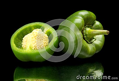 Closeup halved green bell peppers isolated on black Stock Photo