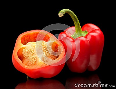 Closeup halved red bell peppers isolated on black Stock Photo