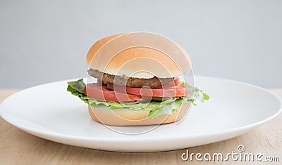 Closeup of Hamberger, It`s junk food put on woodentable in food court Stock Photo