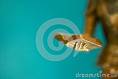 Closeup of the hand of a bronze statue holding an open book. Sculpture closeup. Small depth of field Stock Photo