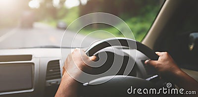 closeup hand driver car on road with sunshine Stock Photo