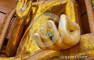 Closeup at hand of Gold big buddha statue temple wat tham sua Stock Photo
