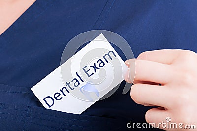 Closeup hand hold visit card with dental exam Stock Photo