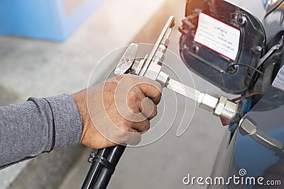 Hand of man pumping CNG gas in car at gas station Stock Photo