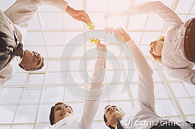 Closeup Hand of People Connecting Jigsaw Puzzle Stock Photo