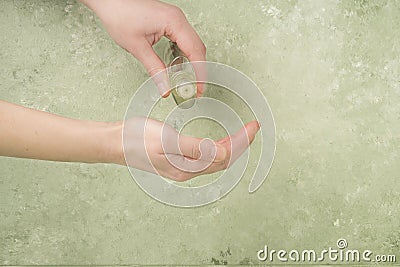 Closeup hand of a person holding bottle of cologne Stock Photo